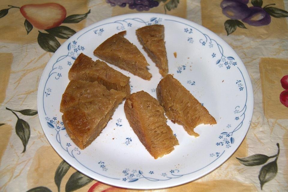 Wedges of Kalathappam, a steamed rice cake, on a plate