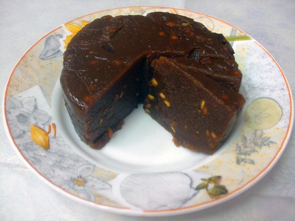 A round, dark Kinnathappam cut open to show the inside
