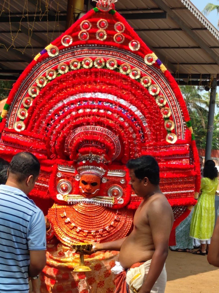 Close view of the Arya Poonkani Theyyam face and headdress