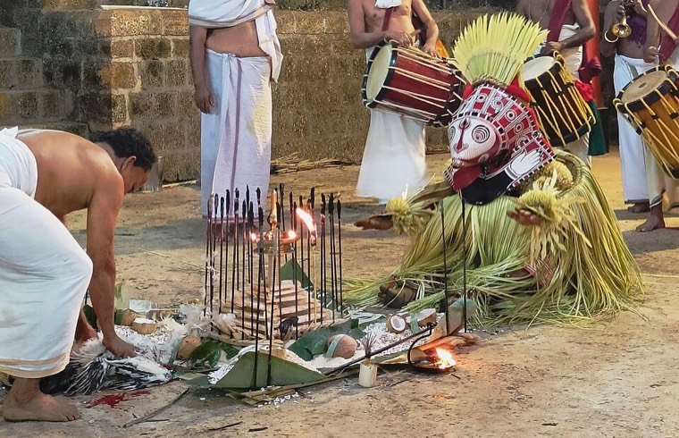 Close view of the Karimchamundi Theyyam face and headdress