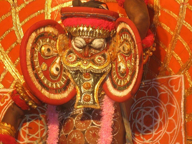 Close view of the Kuttichathan Theyyam face and headdress