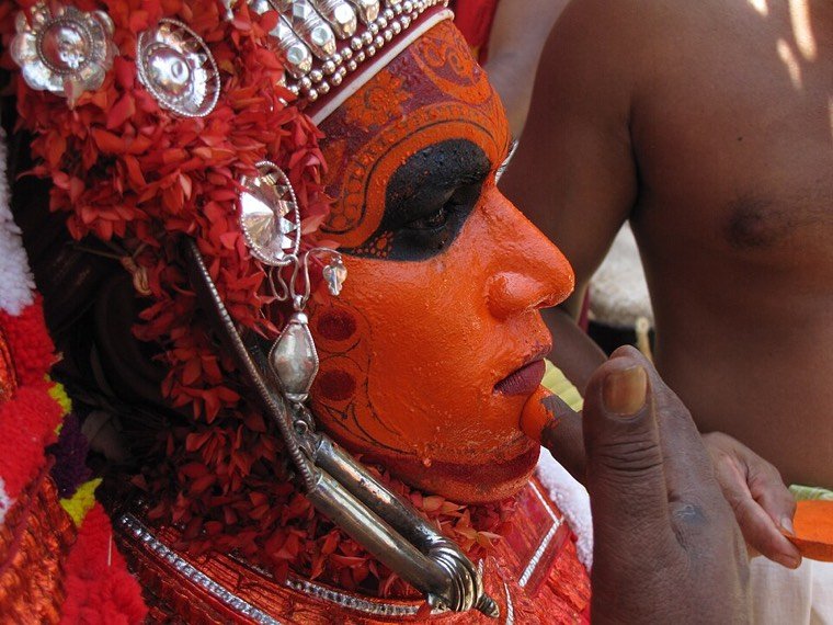 Close view of the Madayil Chamundi Theyyam face and headdress