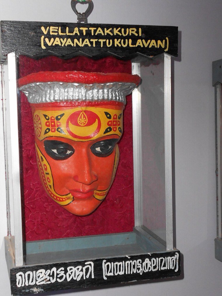 Close view of the Vayanattu Kulavan Theyyam face and headdress